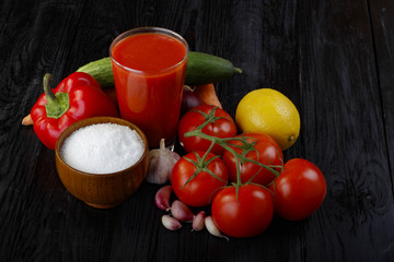 tomato juice and vegetables on wooden background