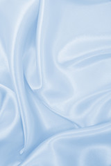 Smooth elegant blue silk or satin luxury cloth texture as abstract background. Luxurious background design