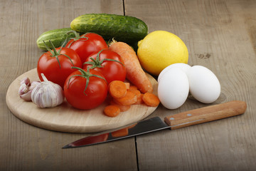 vegetables and eggs on wooden background