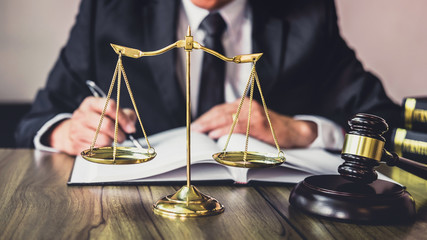 Judge gavel with Justice lawyers, Gavel on wooden table and Counselor or Male lawyer working on a...