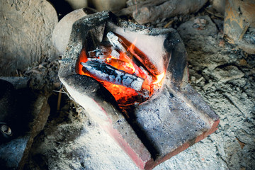 The charcoal fire is black and the fire is burning.