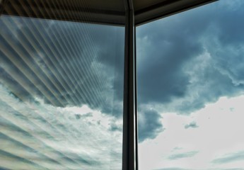 Reflection of the clouds and the sky in the window glass, background