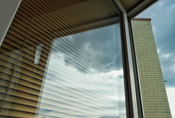 Reflection of the clouds and the sky in the window glass, background