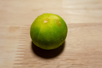 fresh limes on wooden table