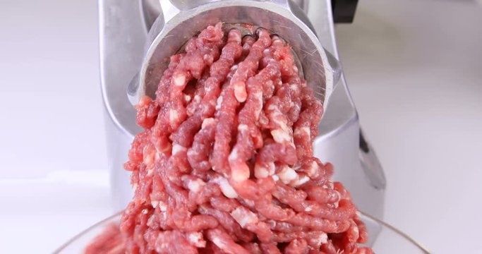 Making minced meat in an electric meat grinder from fresh beef at home