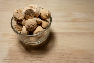 Candy in a bowl on wooden table