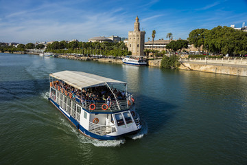 Fluvial cruise along the Guadalquivir River, Torre del Oro in the background in the city of...
