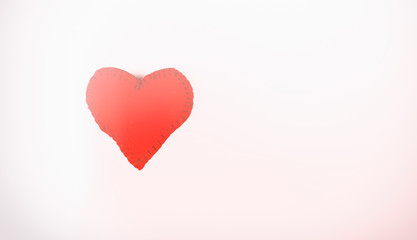 Heart made of fabric on a white background with the effect of multi-exposure and blur on a white background.