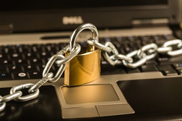 Padlock and Chain on a Laptop