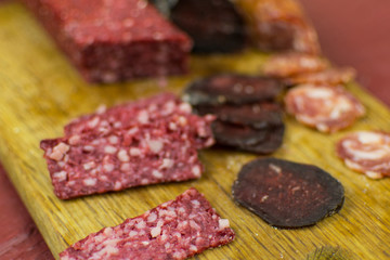 Smoked sausages are cut on a cutting board.