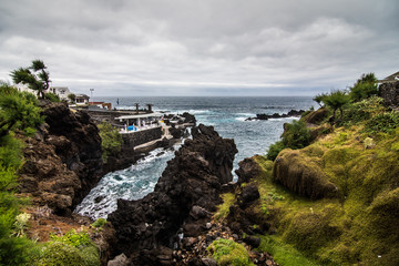 Lava rocks natural volcanic pools in Porto Moniz, Madeira, Portugal.