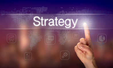 Obraz premium A hand selecting a Strategy business concept on a clear screen with a colorful blurred background.