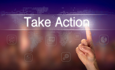 A hand selecting a Take Action business concept on a clear screen with a colorful blurred background.