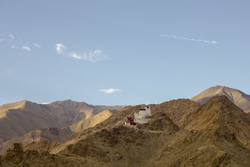 Fototapeta na wymiar Tibetan Buddhist monastery on the sand mountain