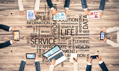 Top view of businesspeople sitting at table and using gadgets