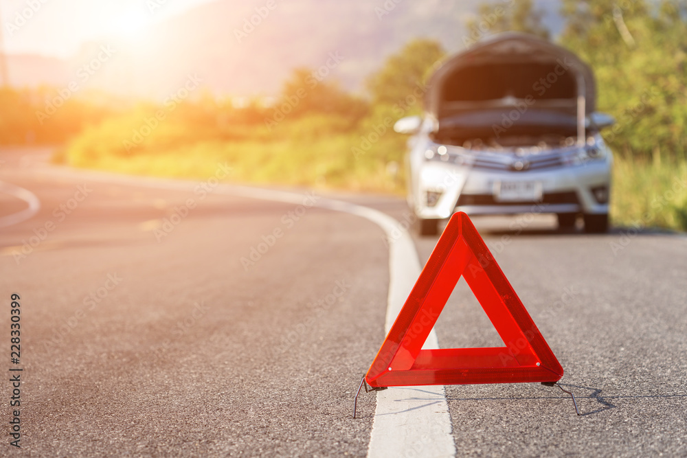 Wall mural red emergency stop sign and broken car on the road