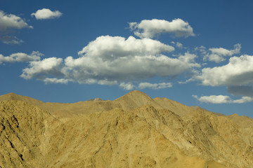 daytime sky with clouds over the desert mountains