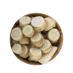 roots of fennel in wooden cup isolated. top view