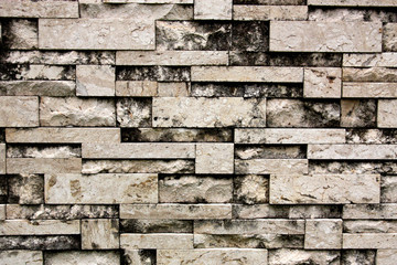 Stone wall background. Stone wall that combines many types of stone together. Texture seamless.