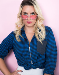 Young blonde woman wearing shirt and sunglasses