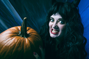 Halloween Witch or Devil ,Beautiful young woman in witches costume