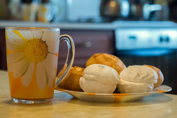 morning tea in a yellow mug with marshmallows and buns