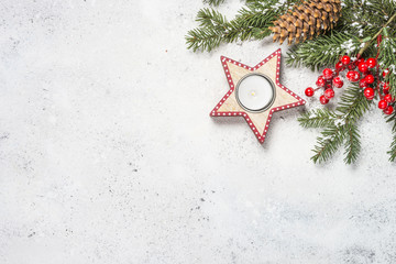 Christmas background with fir tree, candle and decorations on wh