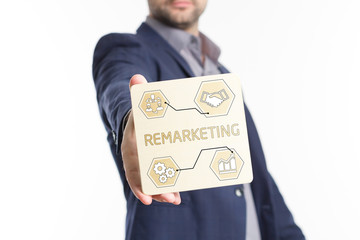 The concept of business, technology, the Internet and the network. Young businessman showing inscription: Remarketing