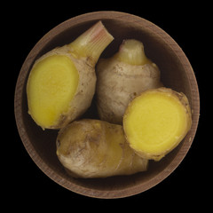 slices of ginger root isolated on black