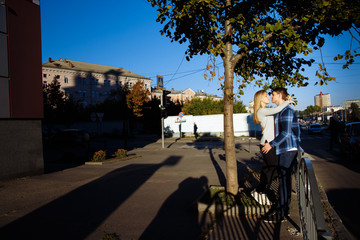 Portrait of a happy couple hugging in the street, in the city.standing in better from the sun, hard light. date