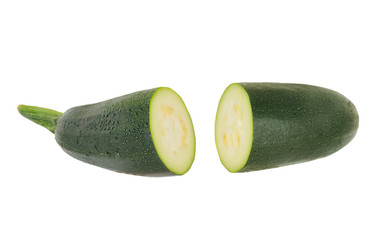 two halves of green zucchini isolated on white