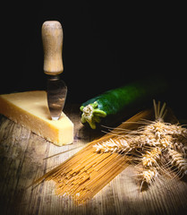 Fresh zucchini, wholemeal pasta, parmesan on rustic background