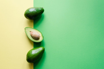 Organic avocado on color background © Nelli Kovalchuk