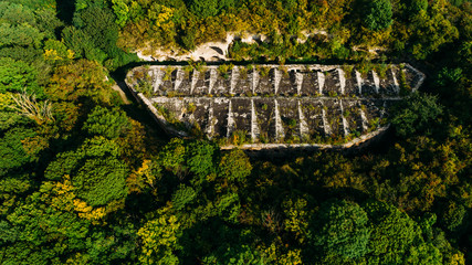 Aerial view of beautiful ancient fortress in forest in summer. Tarakaniv Fort.