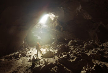 Backpacker man in cave