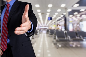 Man wearing a business suit reaching hand