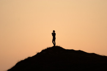 silhouette of woman on top of the mountain
