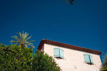 Fototapeta na wymiar House in Provence with palm tree and blue sky