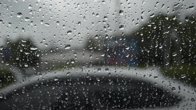 slow motion, rain drops on window car