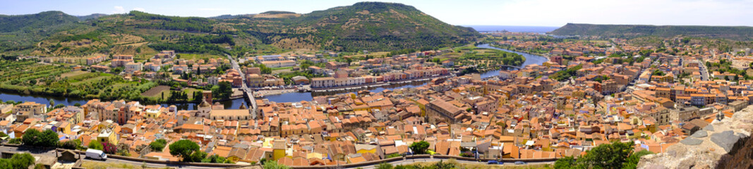 Fototapeta na wymiar Bosa, Italy - Panoramic view of the historic town of Bosa at the western coast of Sardegna by the Fiume Temo river and Bosa Marina in the background