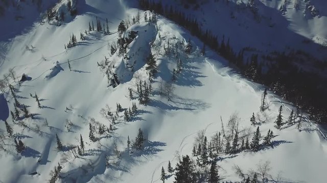 Aerial drone shot ski trail of snowy mountain slope