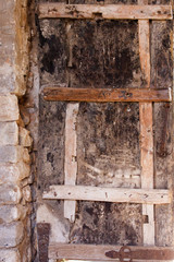 Old monastery wooden door details with metal parts