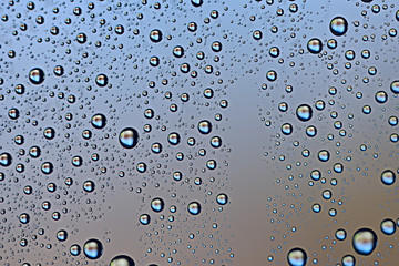 fresh drops background blue glass / wet rainy background, water drops transparent glass blue