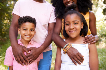 Mid section of black couple and their two children, portrait - Powered by Adobe