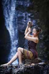 Beautiful girl with waterfall