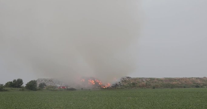 Firefighters at Landfill Garbage Fire With Heavy Smoke Pollution