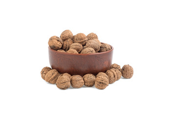 walnut in a clay bowl on a white background