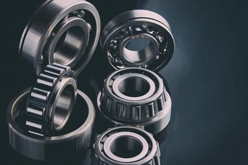 Close-up of a set of ball and roller bearings on a dark background