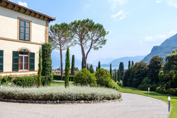 Curved road to a mansion with lights on sides