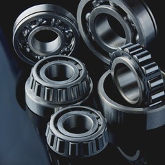 Close-up of a set of ball and roller bearings on a dark background